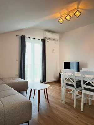a living room with a couch and a table at Villa Bubanja with shared pool in Kotor