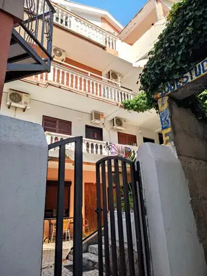a black gate in front of a building at Aloft Apartment in Budva
