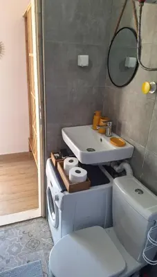 a bathroom with a sink and a toilet at Aloft Apartment in Budva
