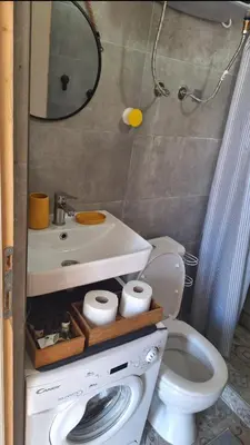 a bathroom with a toilet and a sink and a mirror at Aloft Apartment in Budva