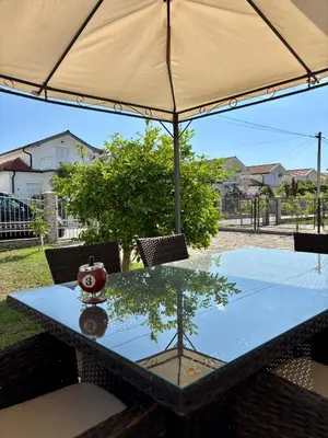 a table with an umbrella on top of it at Hida Ile apartments in Ulcinj