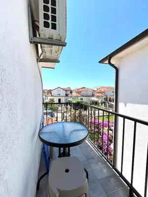 a small table on a balcony with a view at Hida Ile apartments in Ulcinj