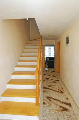a stairway in a home with a wooden stair case at Apartments Ajla in Utjeha