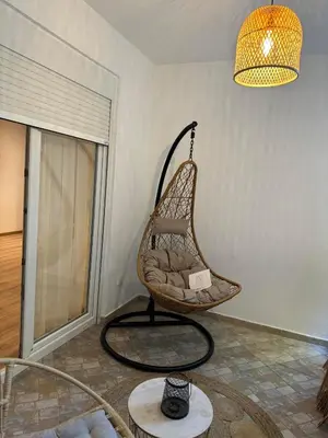 a chair in a living room with a lamp at Apartments Casa Pineta in Ulcinj