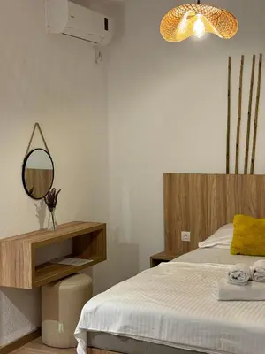 a bedroom with a bed and a mirror on the wall at Apartments Casa Pineta in Ulcinj