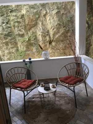 two chairs and a table in front of a window at Apartments Casa Pineta in Ulcinj