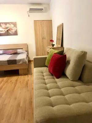 a living room with a couch and a bed at Apartments Casa Pineta in Ulcinj