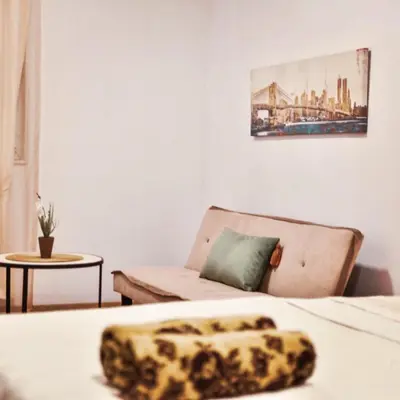 a living room with a couch and a leopard blanket at Apartments Casa Pineta in Ulcinj