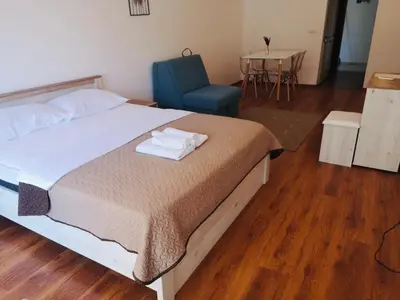 a bedroom with a bed and a chair and a table at Apartments Casa Pineta in Ulcinj