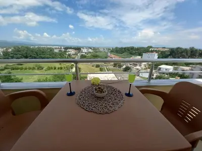 a table with a bowl of food and drinks on a balcony at Apartments Verona in Ulcinj