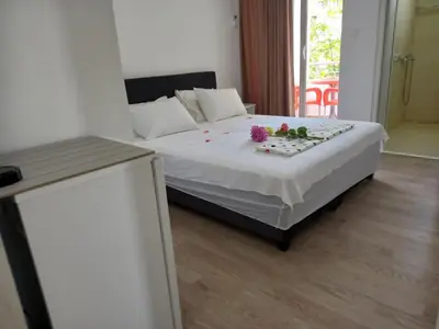 a bedroom with a bed with flowers on it at Apartments Verona in Ulcinj