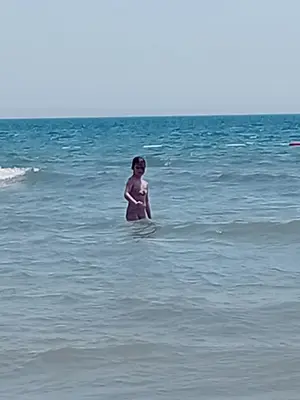 a young child standing in the water in the ocean at Apartments Verona in Ulcinj