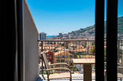 a balcony with a table and a view of a city at Rooftop Apartments & Rooms in Budva