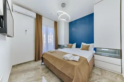 a bedroom with a large bed and a tv at Villa AS in Bar
