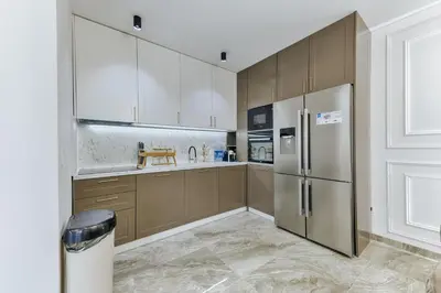 a kitchen with wooden cabinets and a stainless steel refrigerator at Villa AS in Bar