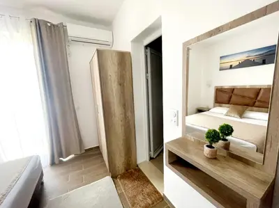 a bedroom with a large mirror and a bed at Dragaj Apartments in Ulcinj