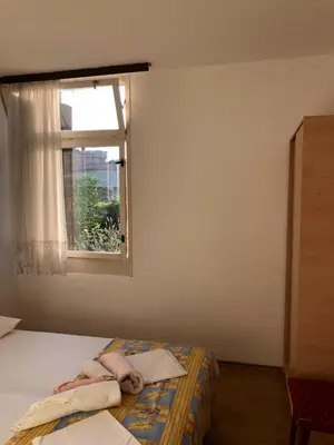 a bedroom with a bed with a person laying on it at Dragana in Petrovac na Moru