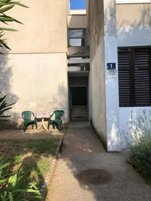a table and two chairs sitting outside of a building at Dragana in Petrovac na Moru