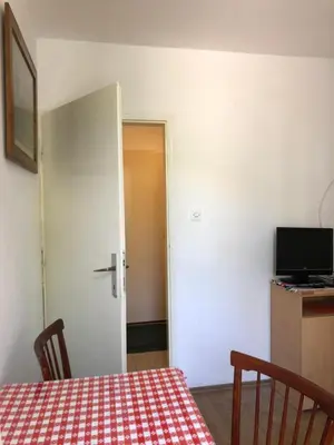 a room with a table with a red and white checkered table cloth at Dragana in Petrovac na Moru