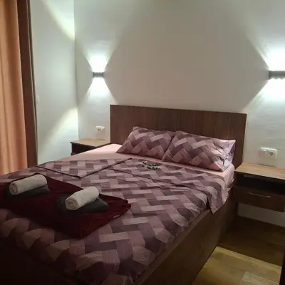 a bedroom with a bed with two towels on it at Orahovo stone vilas in Virpazar