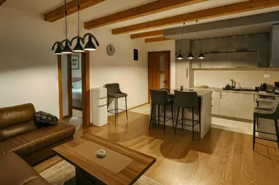 a living room and kitchen with a couch and a table at Orahovo stone vilas in Virpazar