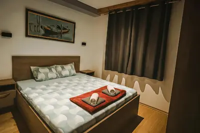 a bedroom with a bed with two shoes on it at Orahovo stone vilas in Virpazar