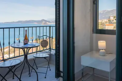 a balcony with a table and chairs and a view of the ocean at Villa Krstac in Budva