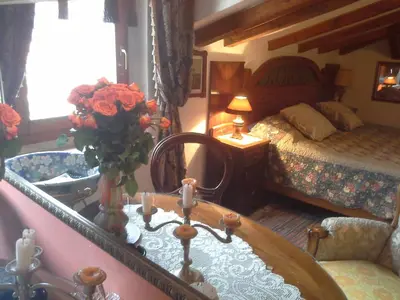 a bedroom with a bed and a table with a vase of flowers at Studios Kono in Kotor