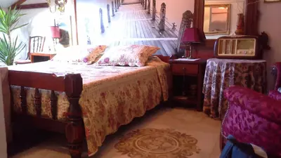 a bedroom with a bed and two tables and a mirror at Studios Kono in Kotor