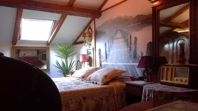 a bedroom with a bed and a painting on the wall at Studios Kono in Kotor