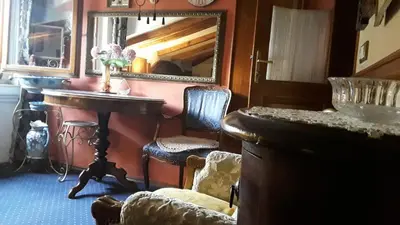 a room with a mirror and a table and chairs at Studios Kono in Kotor