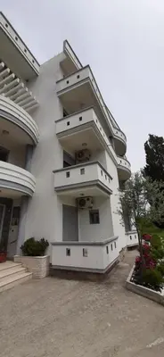 a white building with balconies on the side of it at STANDART Premium in Ulcinj