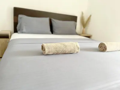 a bed with two rolled up towels on it at STANDART Premium in Ulcinj