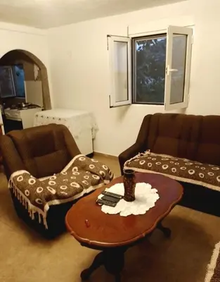 a living room with two chairs and a coffee table at Apartment Lake Oasis ''Oko'' in Krnjice