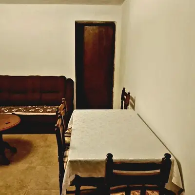 a dining room with a table and a couch at Apartment Lake Oasis ''Oko'' in Krnjice