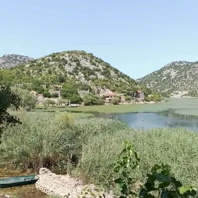 a view of a lake with mountains in the background at Apartment Lake Oasis ''Oko'' in Krnjice