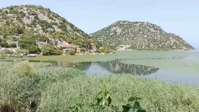 a view of a lake with mountains in the background at Apartment Lake Oasis ''Oko'' in Krnjice