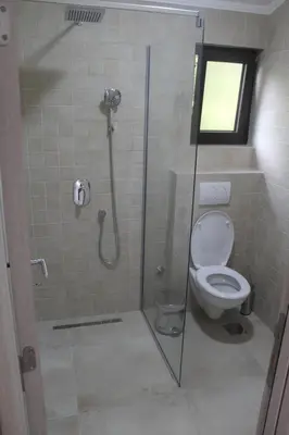 a bathroom with a glass shower with a toilet at MIA CASA Apartmens in Budva