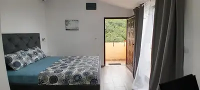 a bedroom with a bed and an open door at MIA CASA Apartmens in Budva