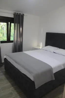 a large bed in a bedroom with a window at MIA CASA Apartmens in Budva