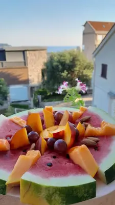 a plate of fruits and vegetables on a table at MIA CASA Apartmens in Budva