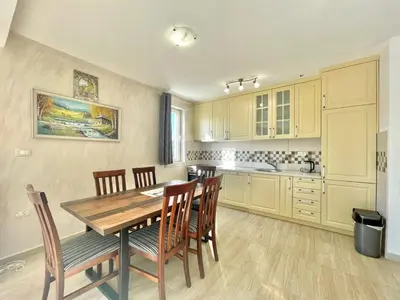 a kitchen with a wooden table and chairs at Villa Petra Zagora in Zagora