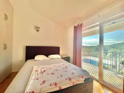 a bedroom with a bed and a large window at Villa Petra Zagora in Zagora