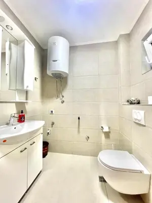 a white bathroom with a toilet and a sink at Villa Petra Zagora in Zagora