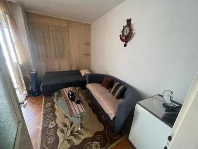 a living room with a couch and a table at A-D free wi-fi internet, air conditioner,free parking in Podgorica