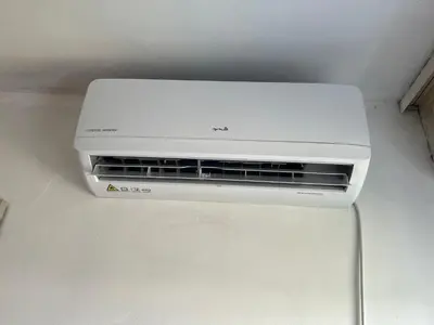 a white air conditioner sitting on top of a refrigerator at A-D free wi-fi internet, air conditioner,free parking in Podgorica
