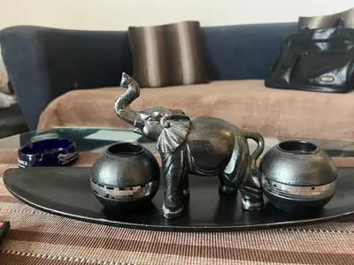 a bronze elephant statue on a plate on a table at A-D free wi-fi internet, air conditioner,free parking in Podgorica