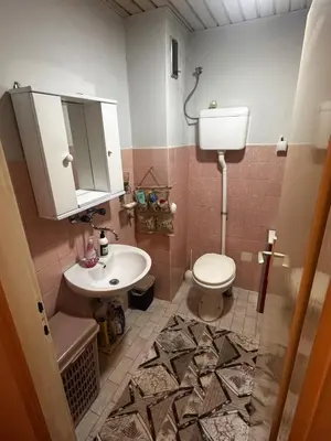 a bathroom with a white toilet and a sink at A-D free wi-fi internet, air conditioner,free parking in Podgorica
