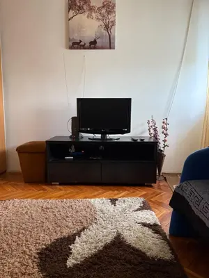 a living room with a flat screen tv on a table at A-D free wi-fi internet, air conditioner,free parking in Podgorica