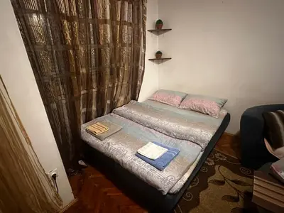 a small bed in a small room with curtains at A-D free wi-fi internet, air conditioner,free parking in Podgorica